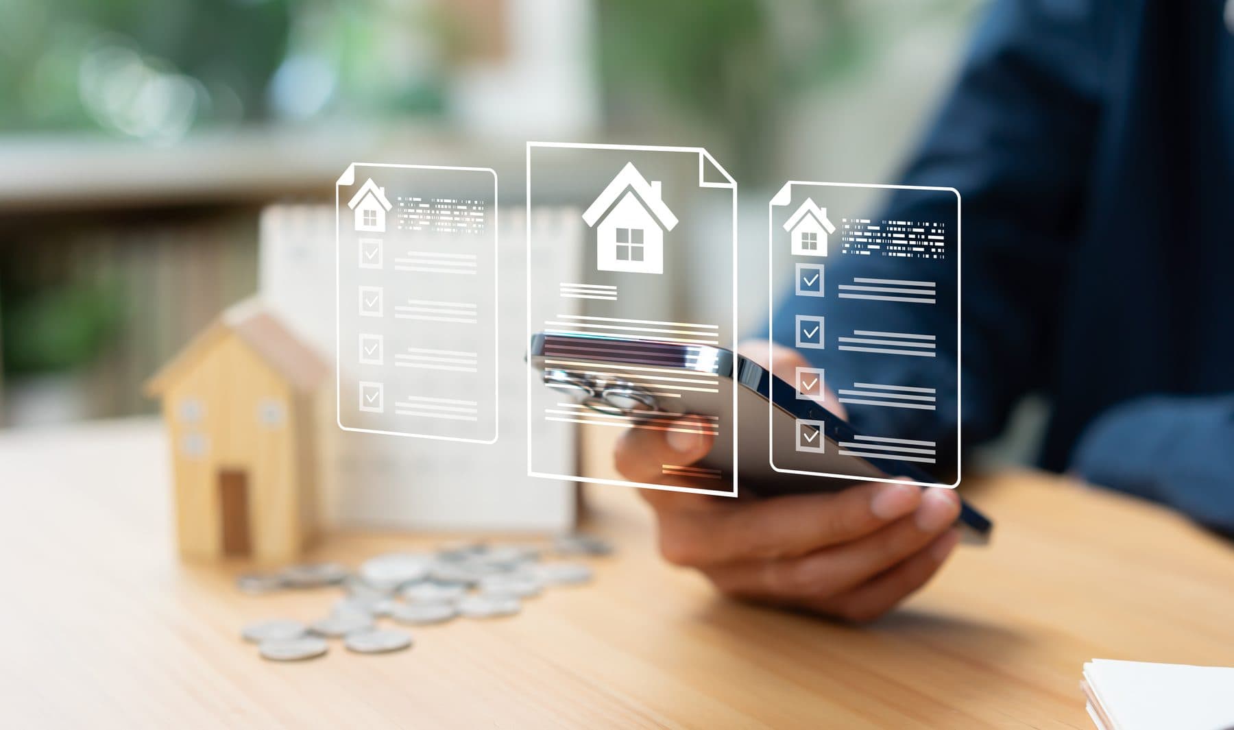 A hand holding a phone beside a model house and stacked coins, with home-loan document graphics floating above