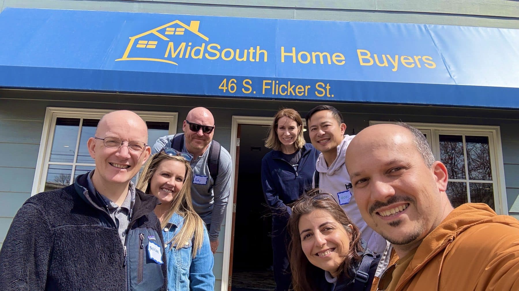 A group of investors on a tour outside the Mid South Home Buyers office on S. Flicker St.
