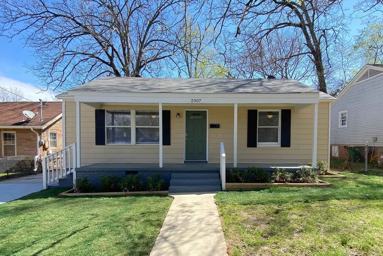 A renovated Little Rock bungalow with a covered front porch and fresh landscaping