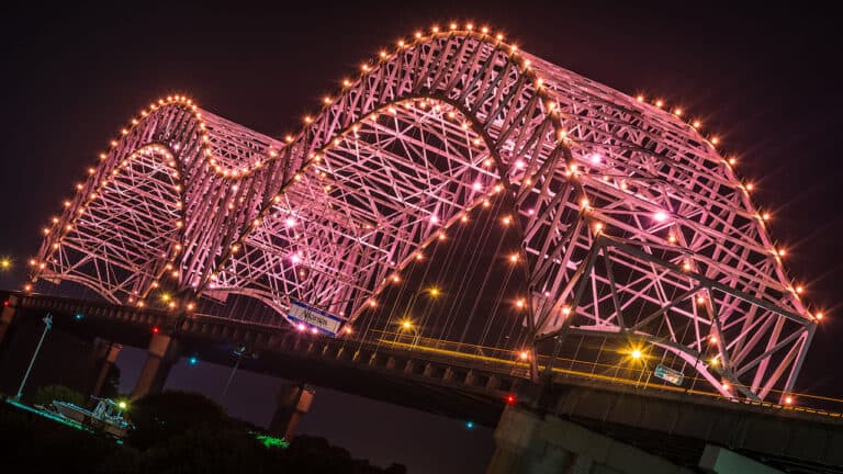 The Hernando de Soto bridge lit up over the Mississippi River in Memphis